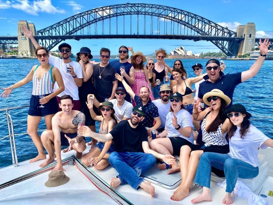 Boat party Sydney Harbour group photo with Sydney Opera House and Sydney Harbour Bridge