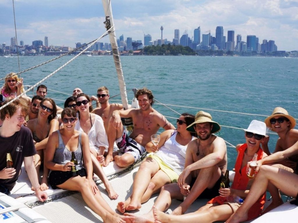 Corporate boat cruise on Rockfish catamaran group photo with Sydney skyline